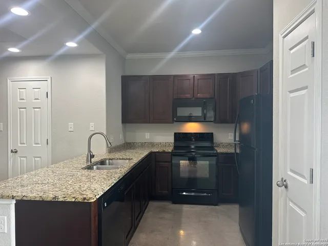 a kitchen with a sink and a refrigerator