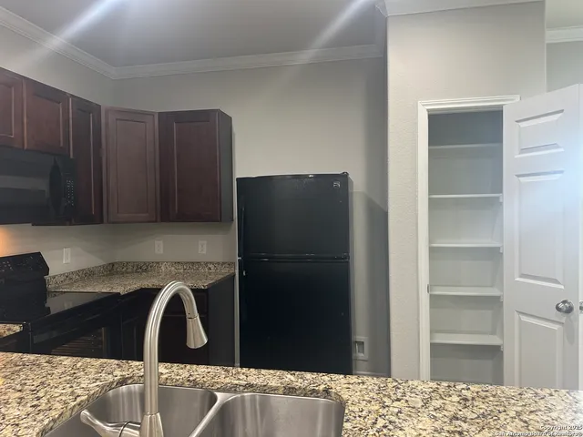 a kitchen with a refrigerator and cabinets