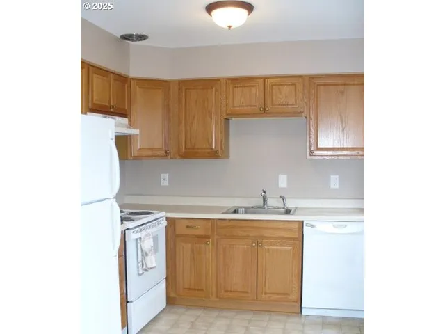 a kitchen with a sink cabinets and appliances