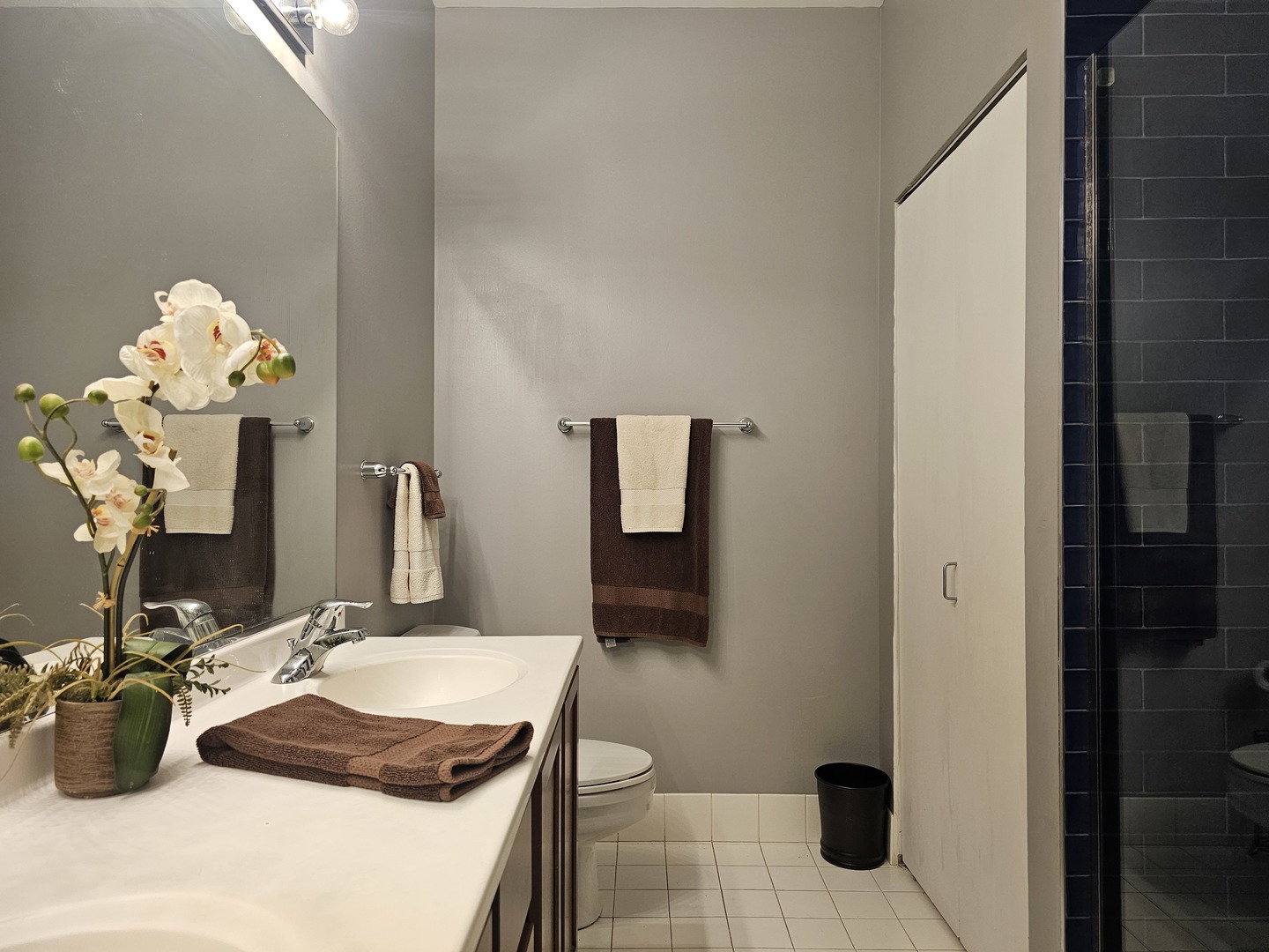 2323 West Pershing Road, Unit 230 Chicago, IL 60609 - Photo 21 of 30 a bathroom with a granite countertop sink a toilet and mirror