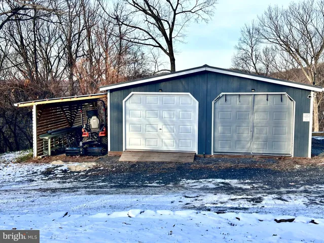 a view of a dry yard with green space