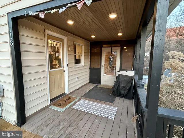 a view of a grassy field with trees