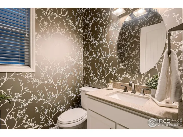 a bathroom with a sink toilet and a mirror