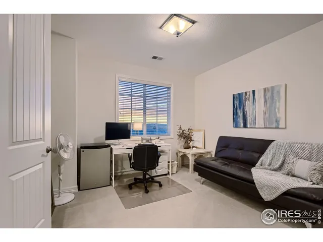 a living room with furniture and a work place