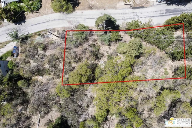 a backyard of a house with lots of green space and trees all around