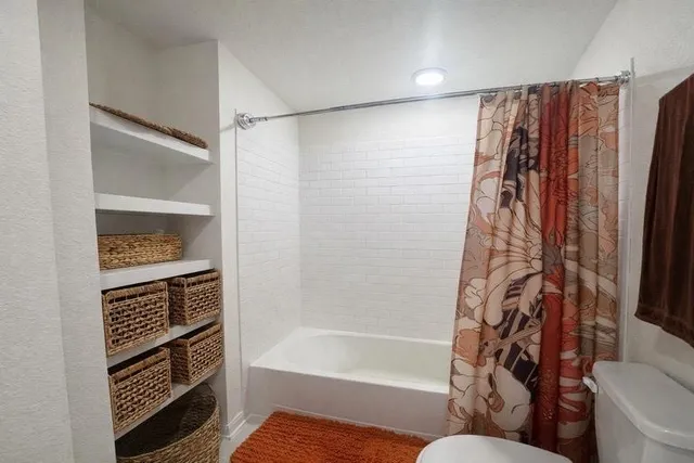 a bathroom with a bathtub and a shower