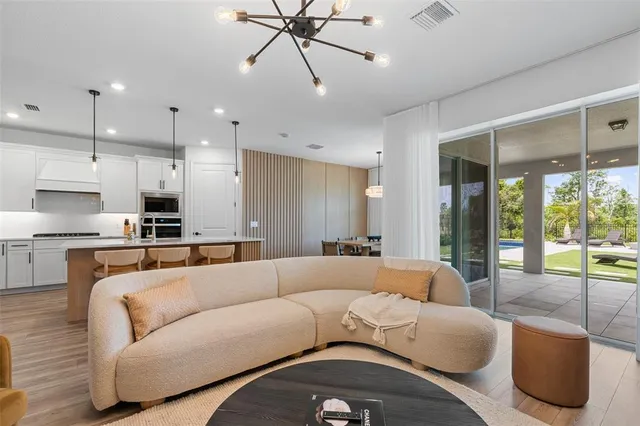a large kitchen with kitchen island a dining table and chairs