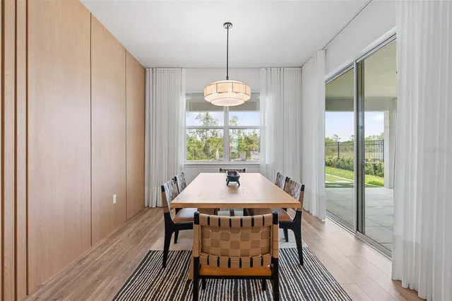 a view of a dining room with furniture window and wooden floor