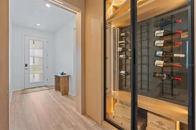 a view of hallway with livingroom and wooden floor