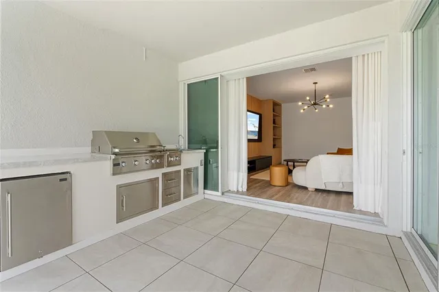 a kitchen with a stove a fridge and a sink