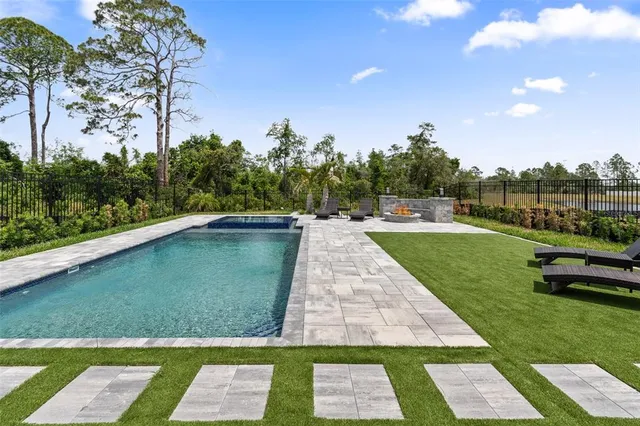 a view of a backyard with sitting area