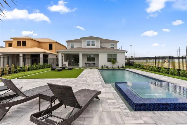 a view of a house with swimming pool and porch