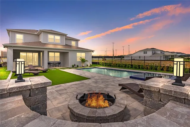 a view of a house with swimming pool and porch
