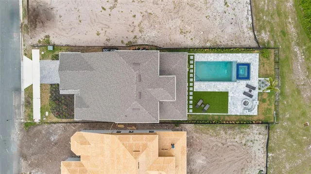 a front view of a house with a yard and potted plants