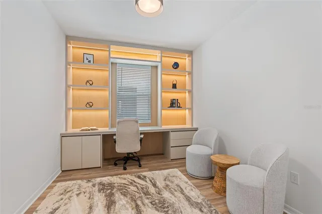 a living room with furniture a large window and a flat screen tv