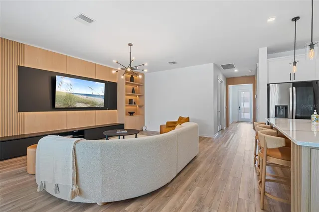 a living room with furniture and a chandelier