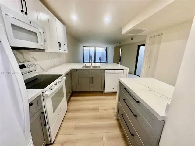a kitchen with a white cabinets and white appliances