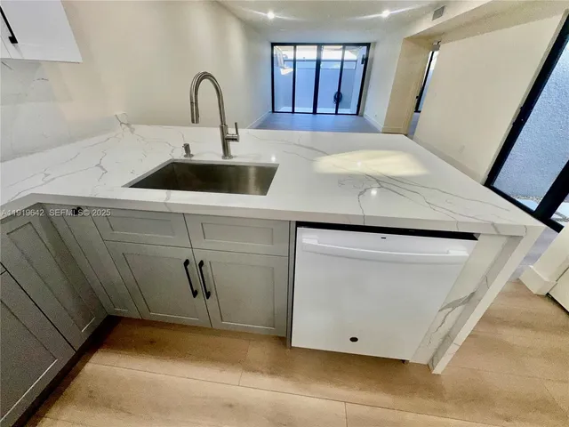 a view of staircase with white walls and a mirror