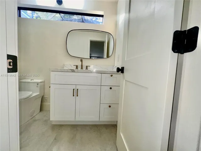 a bathroom with a shower and a mirror