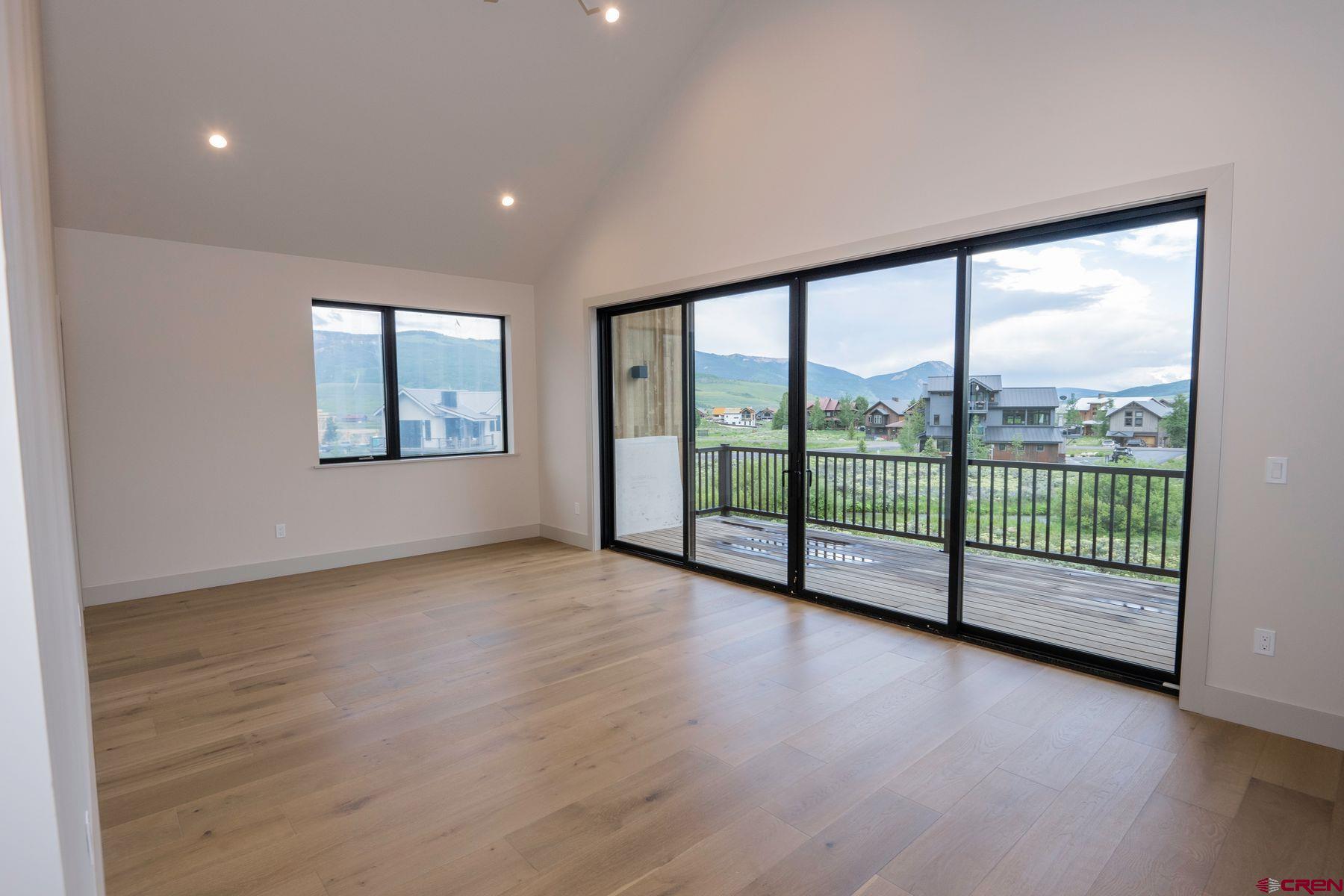 180 Elk Valley Road, Unit 113 Crested Butte, CO 81224 - Photo 12 of 35 a view of a room with wooden floor and floor to ceiling window