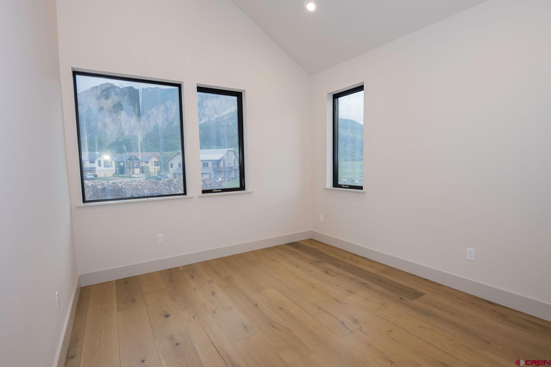 180 Elk Valley Road, Unit 113 Crested Butte, CO 81224 - Photo 21 of 35 a view of a room with wooden floor and window
