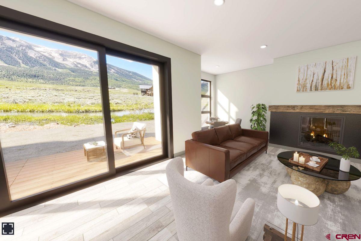 180 Elk Valley Road, Unit 113 Crested Butte, CO 81224 - Photo 30 of 35 a living room with furniture and a floor to ceiling window
