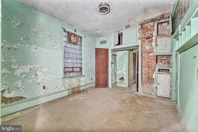 a view of hall way with mirror and stairs