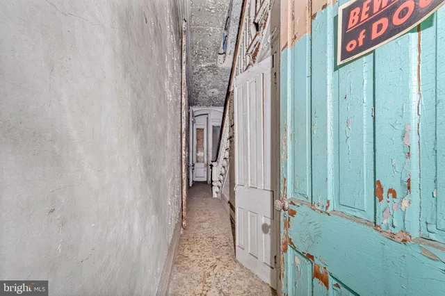 a view of a hallway with wooden floor and walls