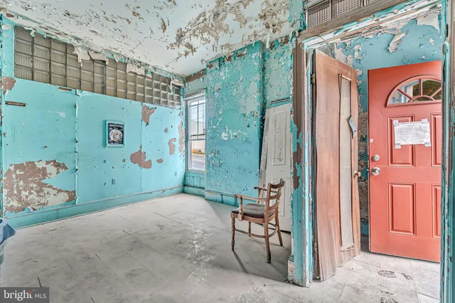 a view of livingroom with a fireplace and chandelier