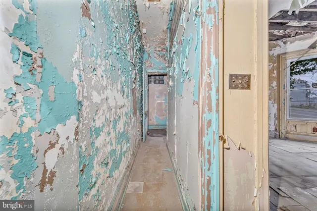 a view of a porch with wooden walls and a door