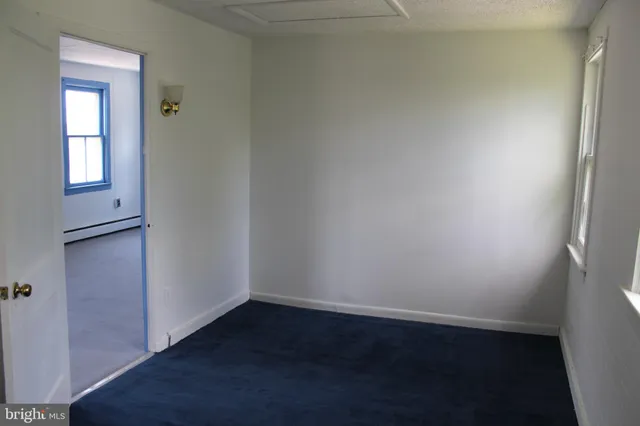 an empty room with wooden floor and closet