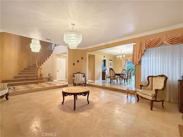 a living room with furniture a dining table and chairs