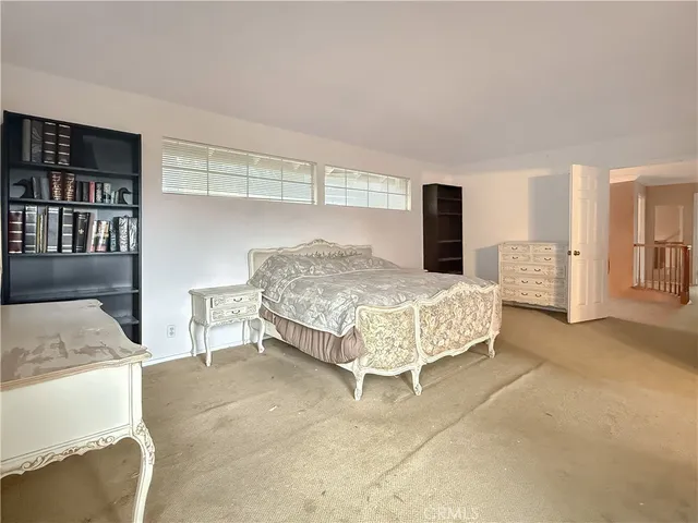 a bedroom with a bed and a cabinets