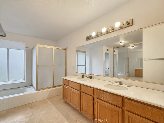 a bathroom with a sink double vanity and a mirror