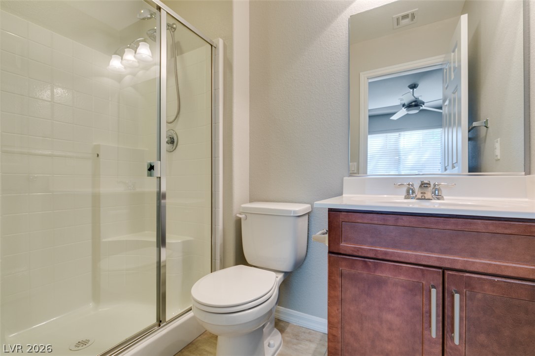 4650 Ranch House Road, Unit 46 North Las Vegas, NV 89031 - Photo 6 of 38 Tiled walk-in shower and stone-counter vanity highlight this modern bathroom space.