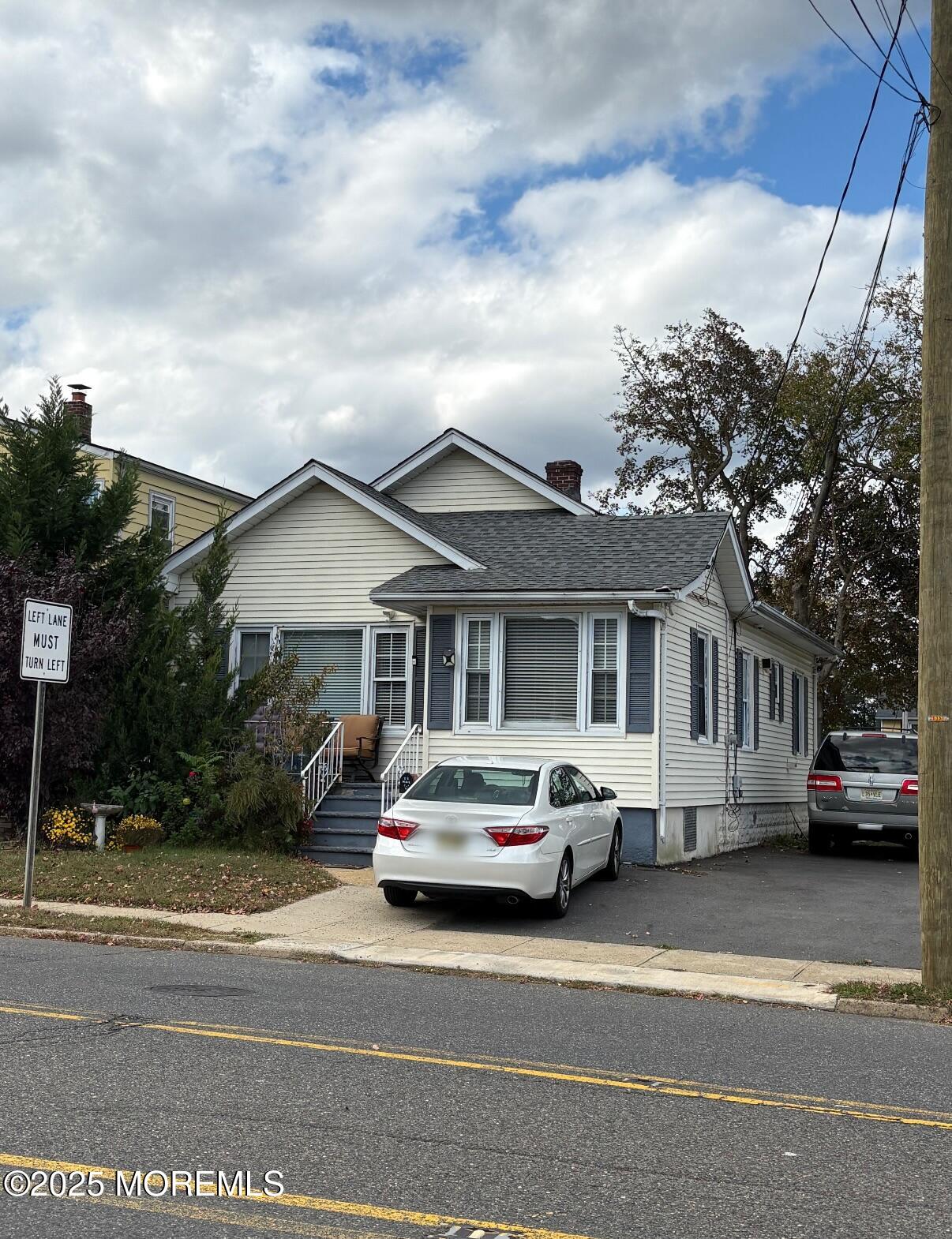 154 Lower Main Street Aberdeen, NJ 07747 - Photo 2 of 10 a car parked in front of a white house