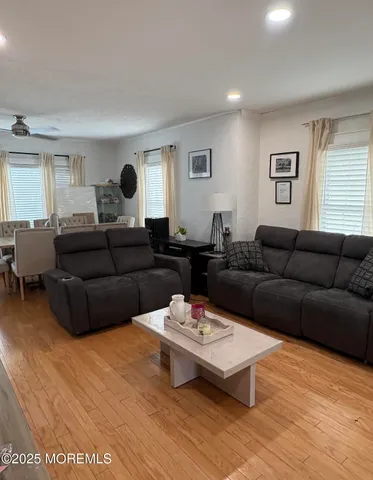 a living room with furniture and wooden floor