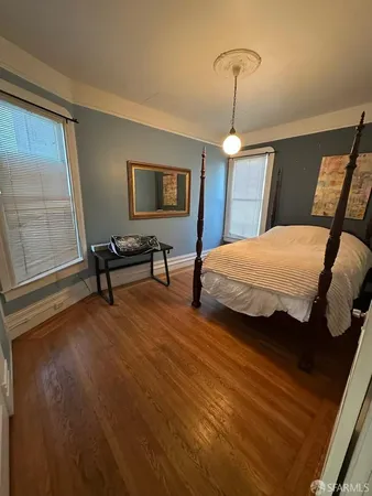 a bedroom with bed and a window
