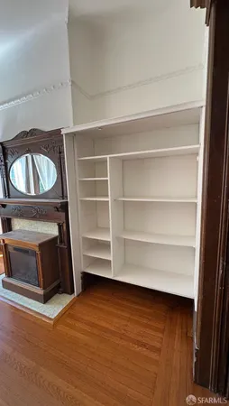 a view of a room with wooden floor and a cabinet