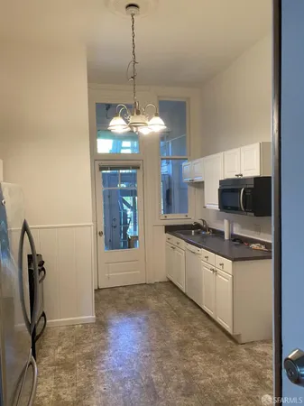 a kitchen with stainless steel appliances granite countertop a sink a stove and a refrigerator