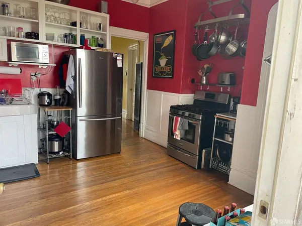 a kitchen with stainless steel appliances granite countertop a refrigerator and a stove