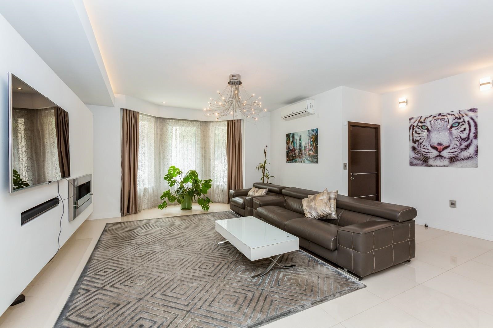 96 Columbia Terrace, Unit 1 Weehawken, NJ 07086 - Photo 2 of 40 a living room with furniture and a flat screen tv