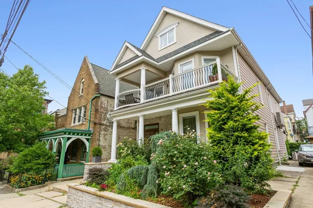 a front view of a house with a garden
