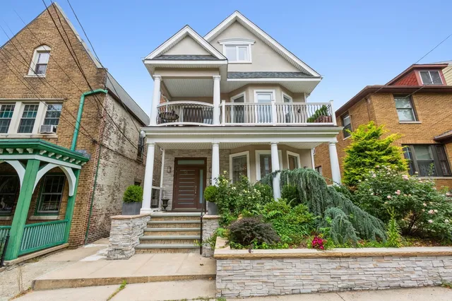 a front view of a house with plants