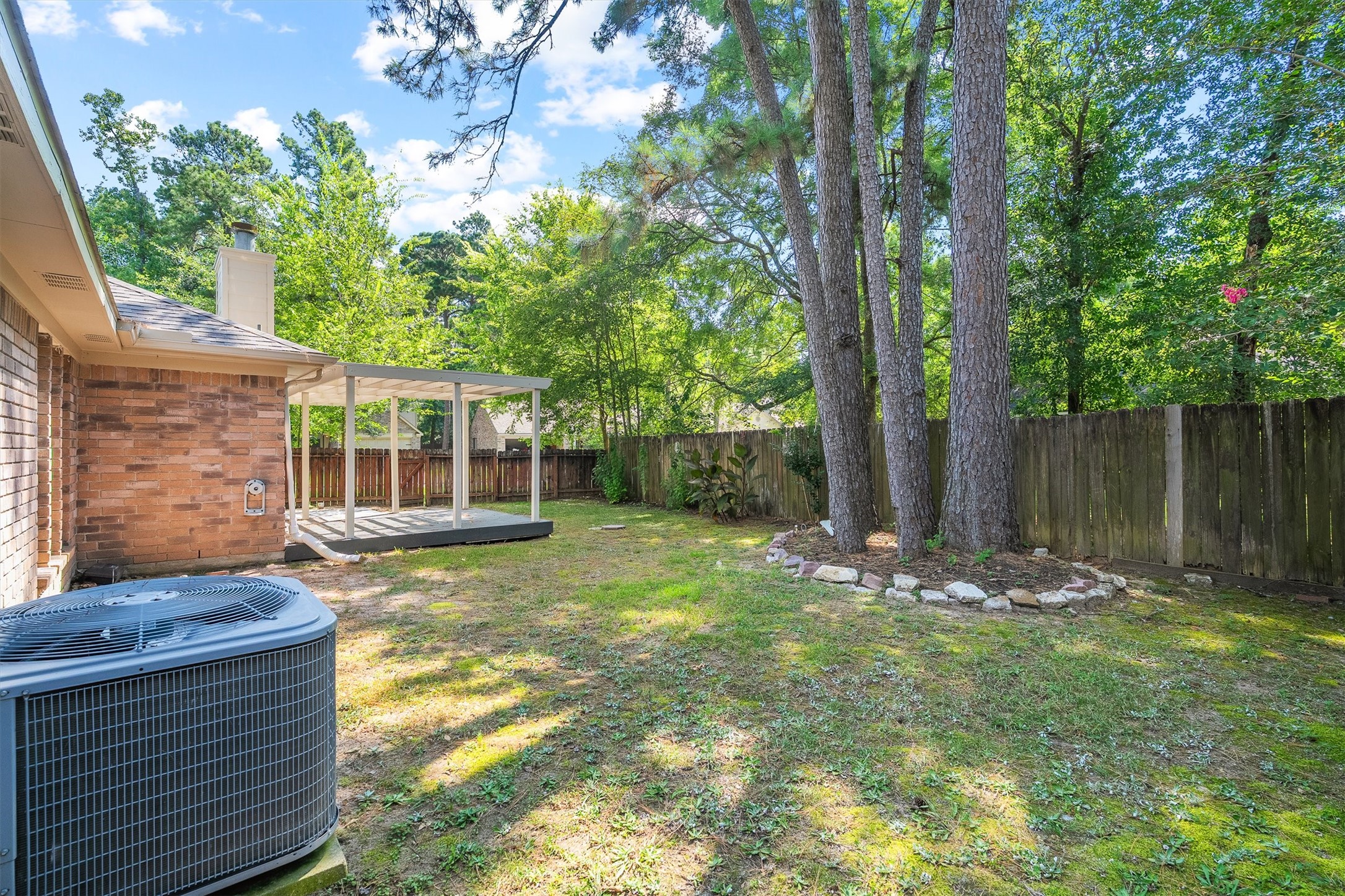 3 Still Corner Place Spring, TX 77381 - Photo 28 of 34 The yard keeps going back here, framed by towering trees, and that same fenced privacy, so much room to add a garden, play space, or just breathe. Backyard yoga anyone?