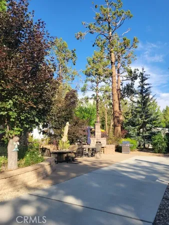 a view of road with a building and trees in the background