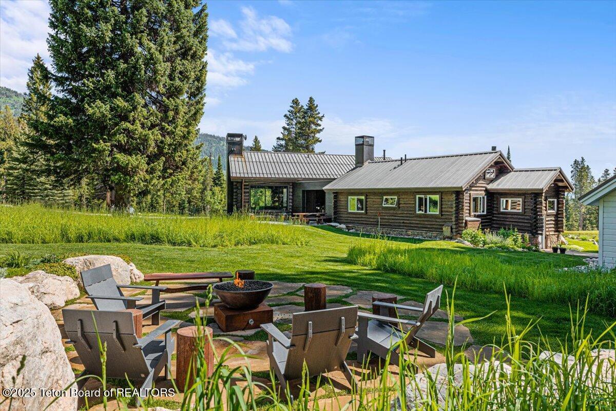 7000 West Gill Huff Road Wilson, WY 83014 - Photo 17 of 37 Outdoor fire and front of house