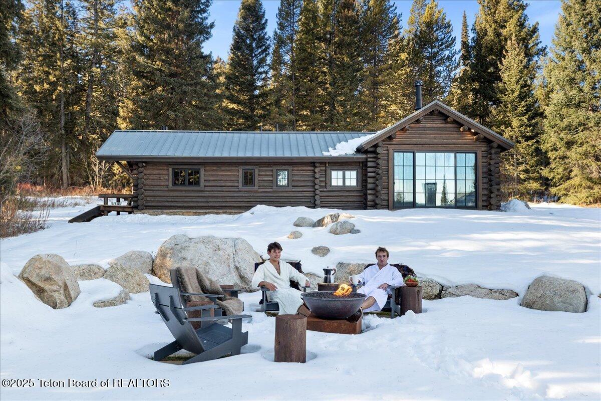 7000 West Gill Huff Road Wilson, WY 83014 - Photo 28 of 37 Outdoor fireplace and robes 2