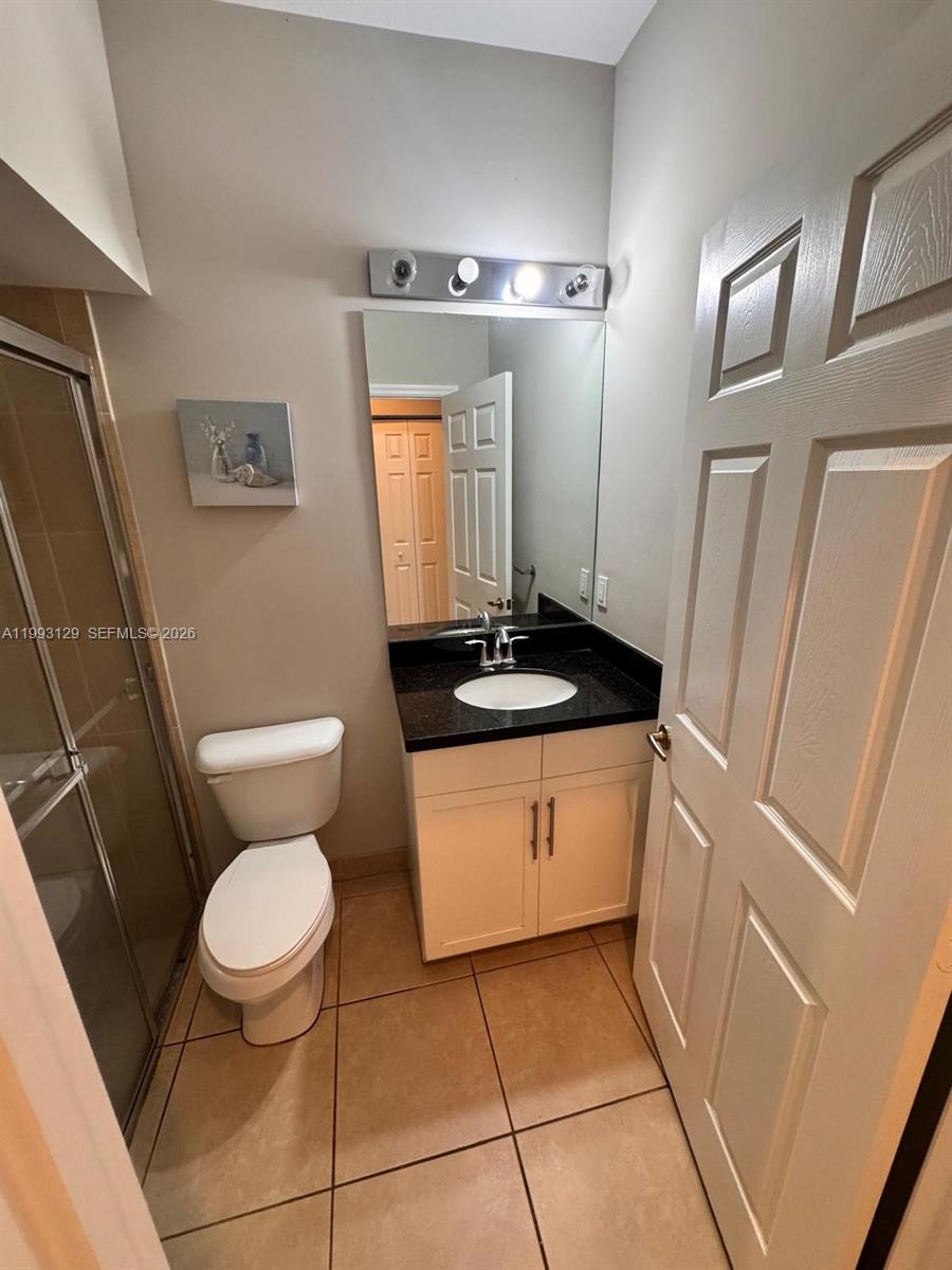 11980 Southwest 29th Street Miramar, FL 33025 - Photo 12 of 56 a bathroom with a granite countertop sink toilet and shower