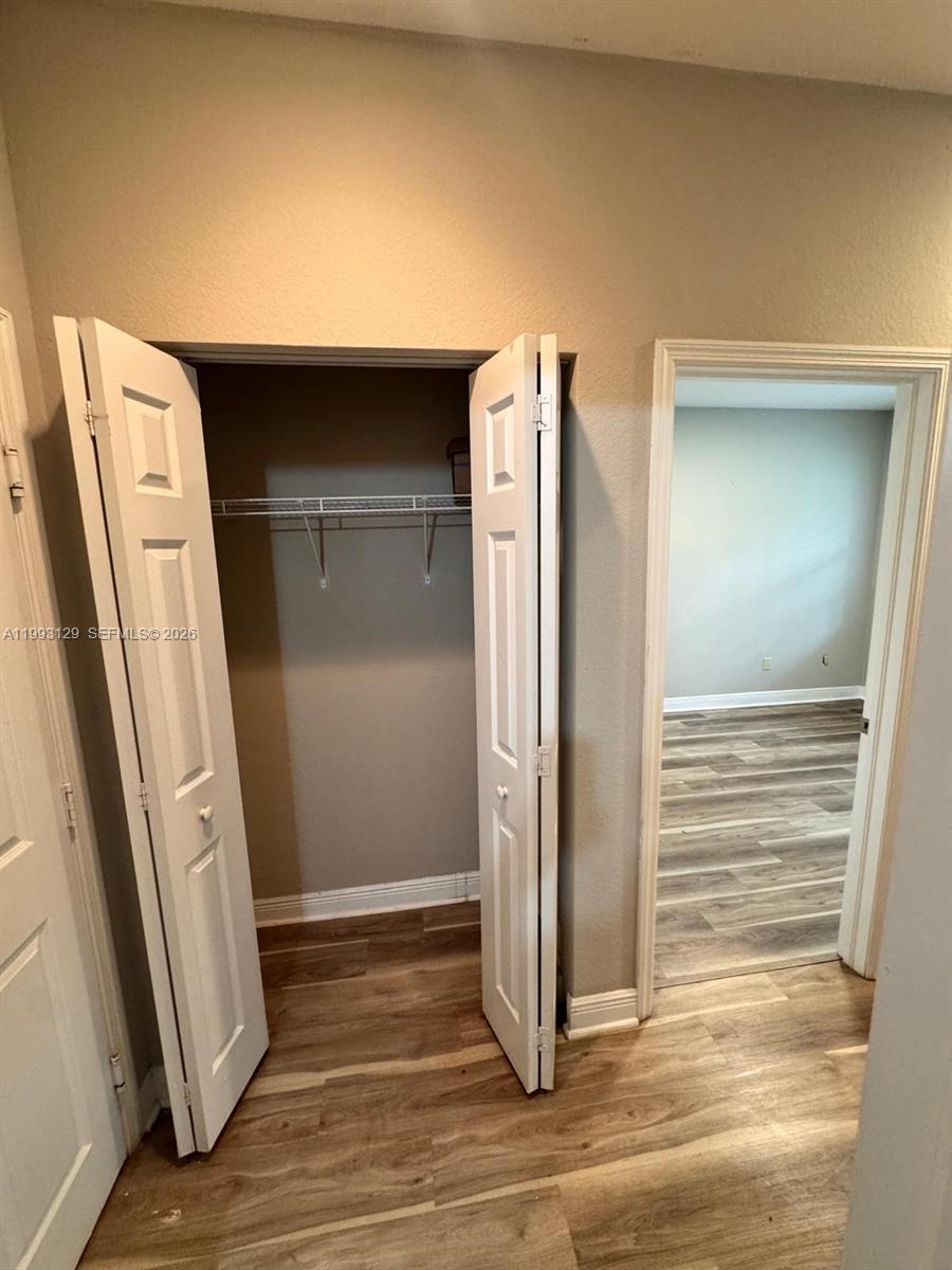 11980 Southwest 29th Street Miramar, FL 33025 - Photo 14 of 56 an empty room with wooden floor and a window